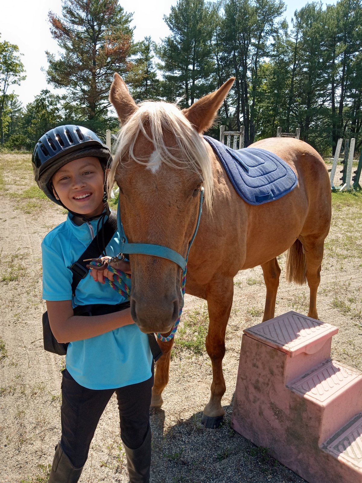 Rider with palomino at mounting block